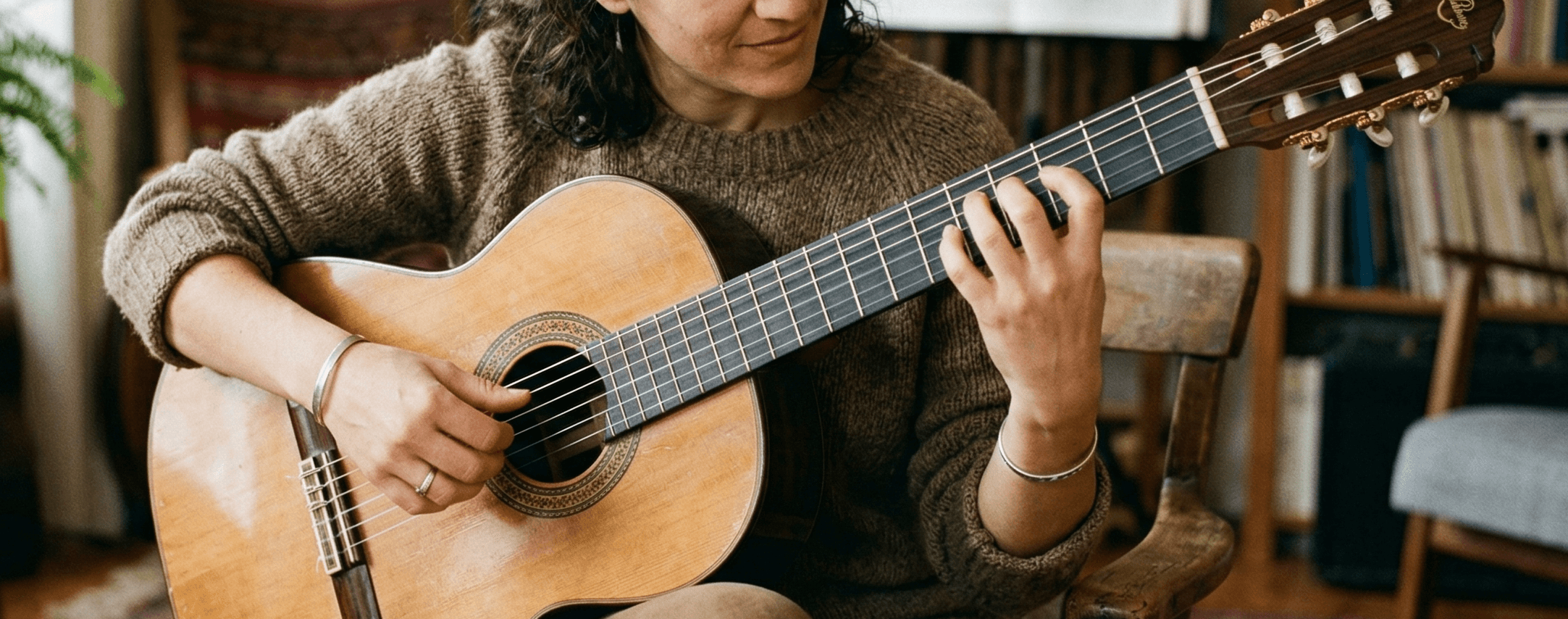 Woman playing classical guitar with proper technique